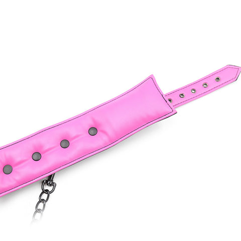 Leather Handcuffed Set - Pink adjustable strap with buttons and chain for BDSM play and sensual exploration.