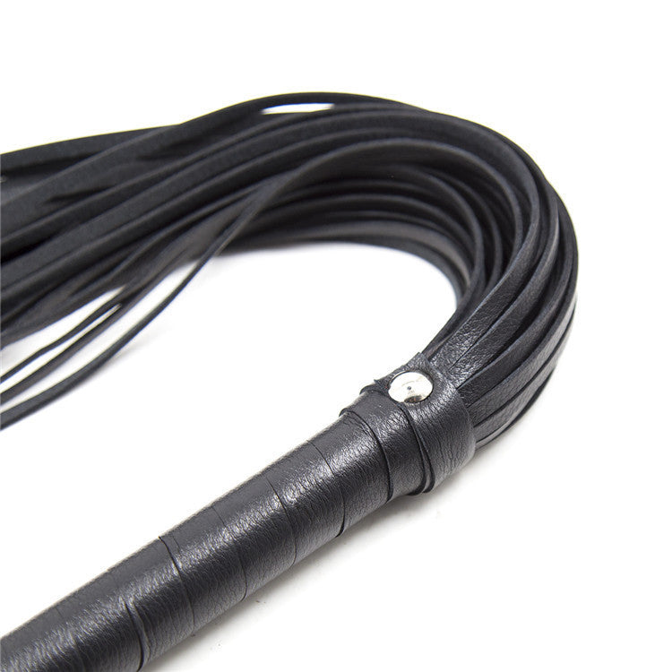 Close-up of a Leather Love Whip designed for sensual BDSM play and adult roleplay.