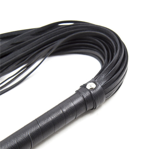 Close-up of a Leather Love Whip designed for sensual BDSM play and adult roleplay.