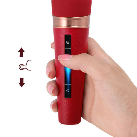 Hand holding the Velura Wand, a red powerful massager with control buttons for versatile stimulation.