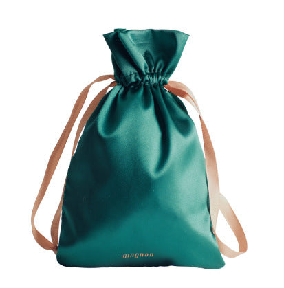 Mini Massage Toys For Women storage bag in teal with drawstring and beige straps.